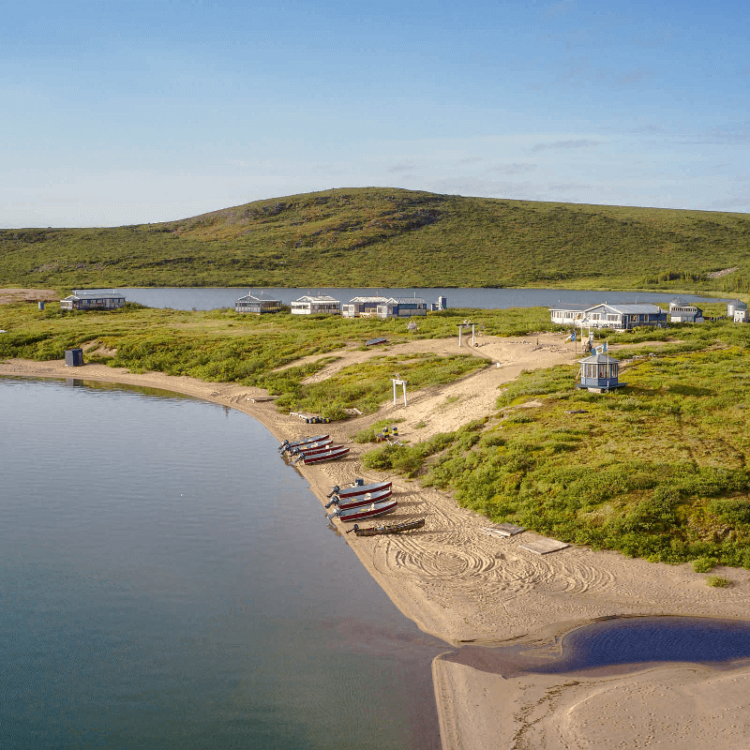 Lodge located on the shores of Point Lake in Canada's Northwest Territories, barrens, boats lined up on sand beach