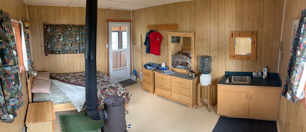 Inside Cabin Suite Queen bed and dresser, mirror and vanity