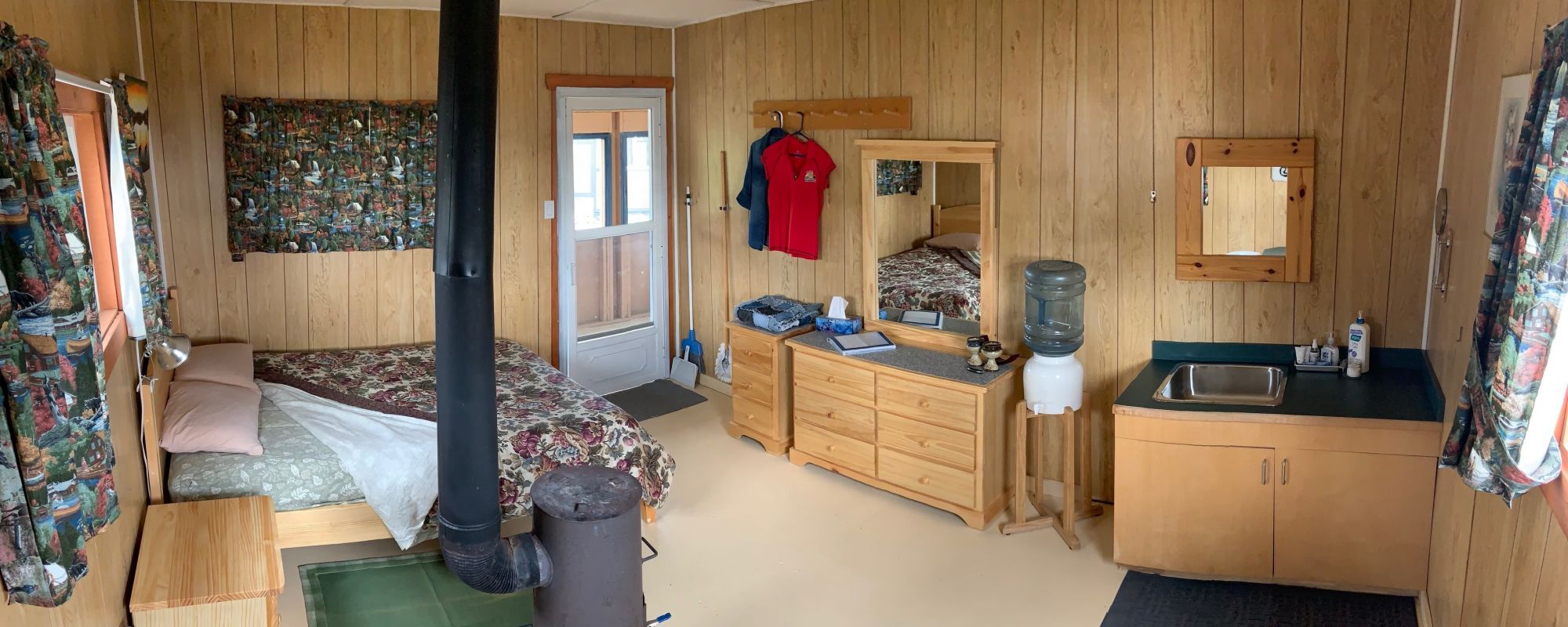 Inside Cabin Suite Queen bed and dresser, mirror and vanity