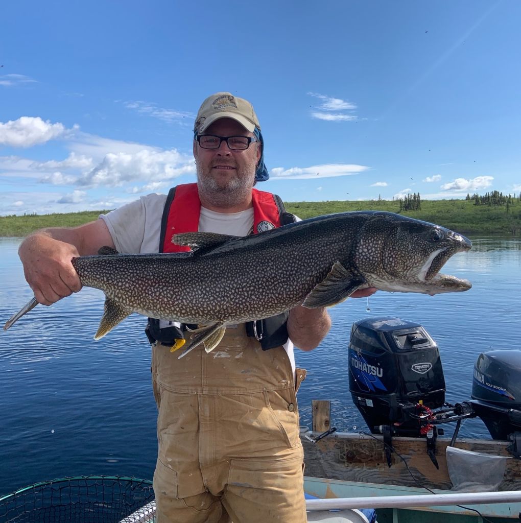 Fisherman holding trophy lake trout