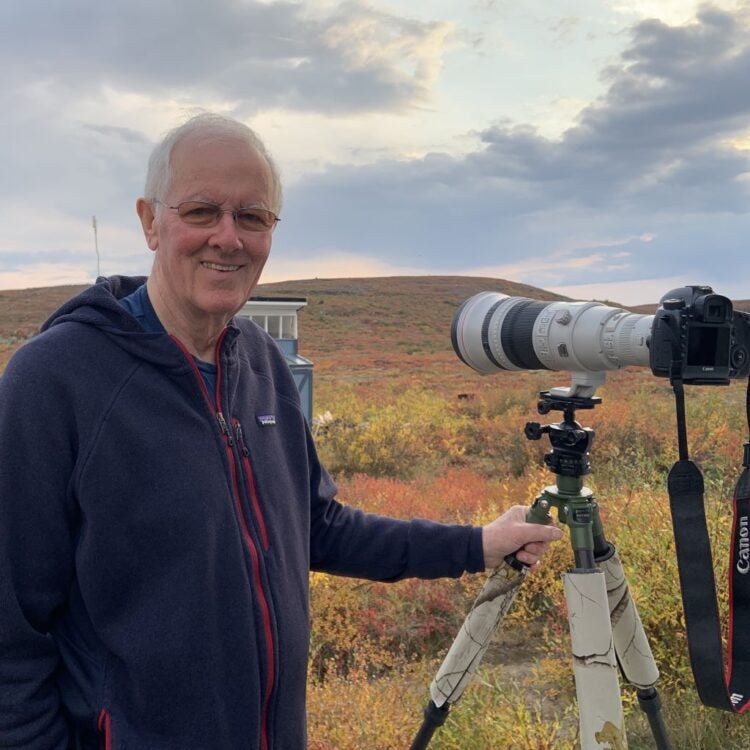 Man smiling with Canon Camera on tripod