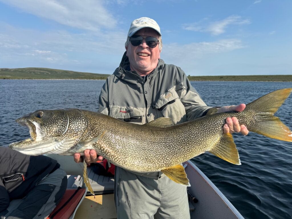 Man holding giant lake trout