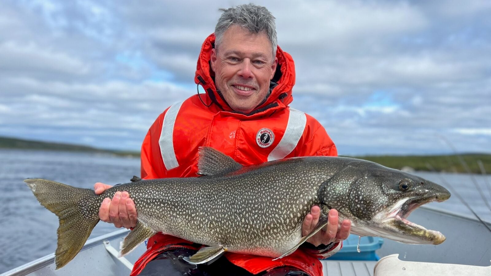 Fisherman holding huge lake trout