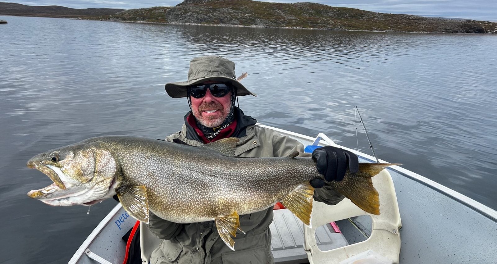 Happy Fisherman holding monster lake trout